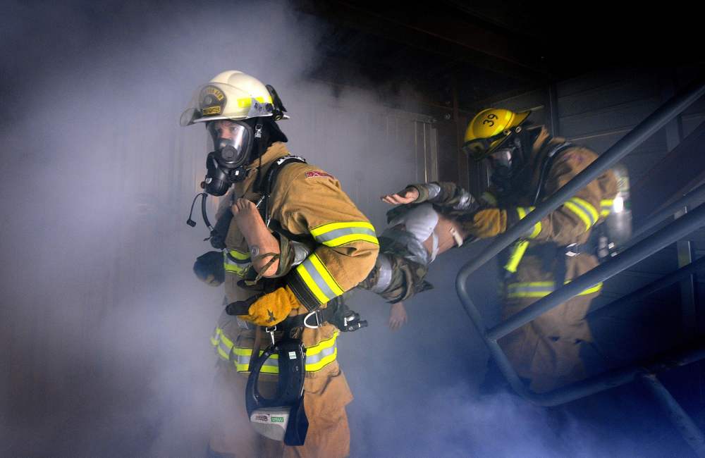 Trainer delivering vocational training on fire evacuation procedures, ensuring workplace HSEQ compliance.